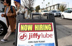 Sign reads "Now Hiring: Jiffy Lube" 