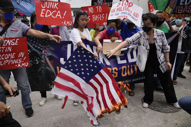 Demonstrators burn a mock U.S. flag as they protest against the visit of U.S. Defense Secretary Lloyd Austin outside Camp Aguinaldo military headquarters in metro Manila, Philippines, on Thursday, Feb. 2, 2023. 