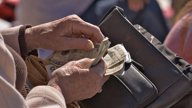 Elderly Woman counting money 