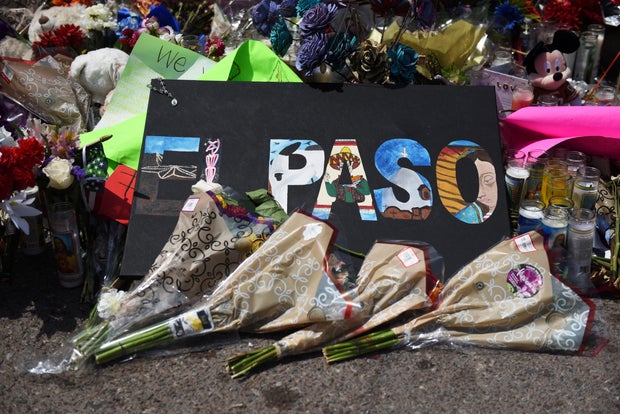 Flowers and candles are seen at a memorial five days after a mass shooting at a Walmart store in El Paso, Texas, August 8, 2019. 