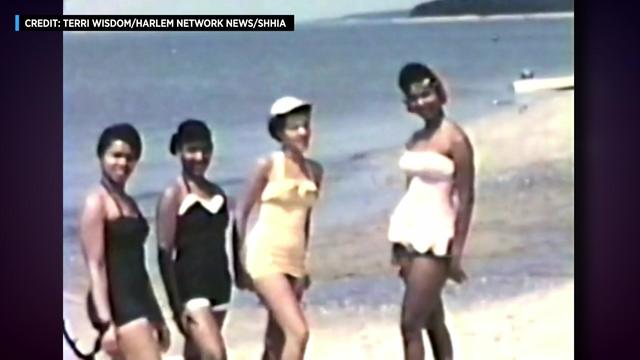 Vintage footage shows Black women standing on a Long Island beach. 