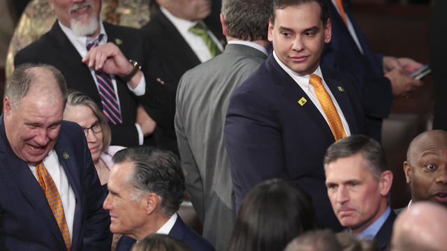 George Santos (R-NY) (top right) watches as Sen. Mitt Romney (R-UT) (bottom left) enters the House chamber for President Joe Biden's State of the Union address during a joint meeting of Congress in the House Chamber of the U.S. Capitol on February 07, 202 