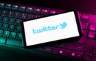 In this photo illustration a Twitter logo seen displayed on 