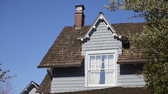 Roof shingles and clear blue sky. Victorian style house 