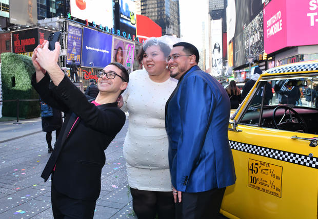 Fashion designer Christian Siriano poses with  Kristen LaBoy and Jesus Torres after officiating their wedding in Times Square on February 14, 2023 in New York City. 