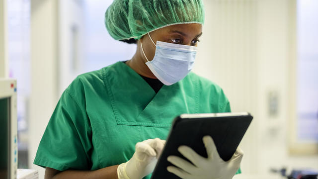 Woman nurse using digital tablet in operating room at eye hospital 