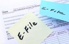 Tax form 1040A with E-file sticky notes 