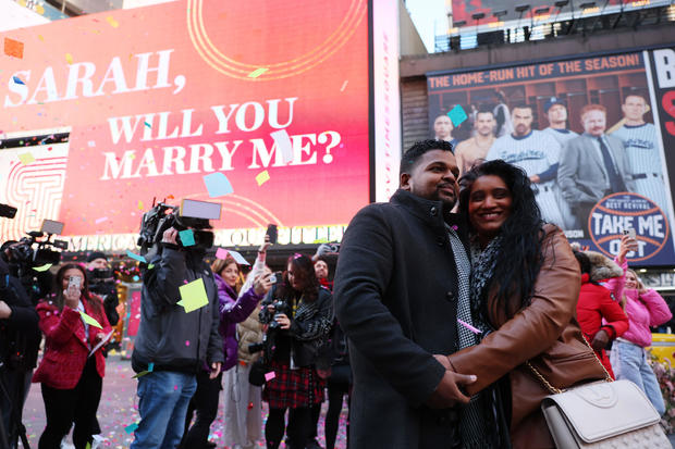 David Machado and Sarah Persaud pose for photos after getting engaged as they celebrate Valentine's Day in Times Square on February 14, 2023 in New York City. 