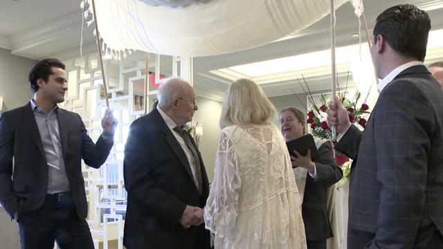 Alice and Morty Steinberg stand under a canopy at their vow renewal ceremony. 