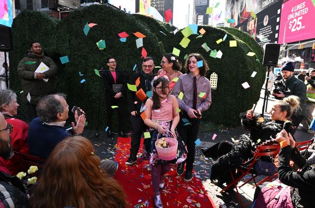 Rachel Federman (C R) and Alexandre Perez (C) leave after getting married by fashion designer Christian Siriano (2nd L rear) during Valentine's Day in New York City's Times Square on February 14, 2023. 