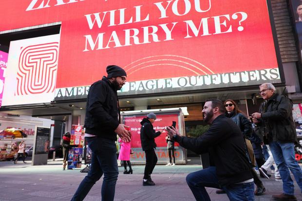 Zaid Kamousi looks down as Gary Puhl proposes as they celebrate Valentine's Day in Times Square on February 14, 2023 in New York City. 
