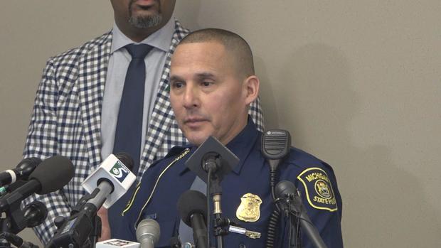 Lt. Rene Gonzalez with Michigan State Police speaking at a podium providing an update on the MSU shooting investigation 