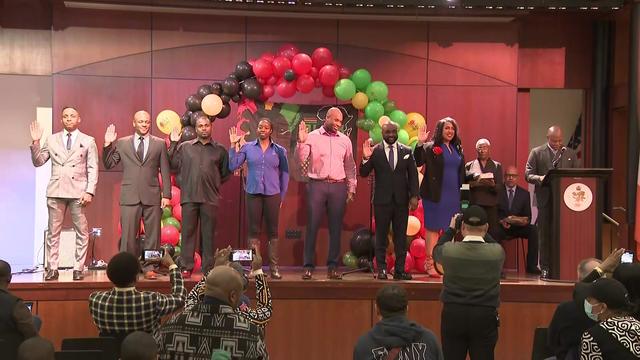 A Vulcan Society executive board stands on a stage during a swearing-in ceremony. 