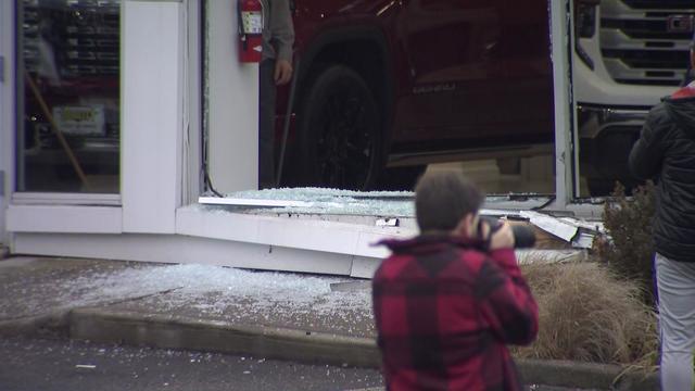 Shattered glass can be seen outside a New Jersey car dealership. 