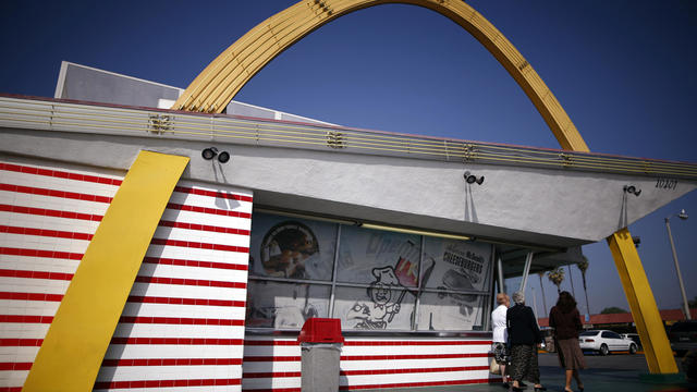 Women walk past a historic McDonald's restaurant in Downey, California 