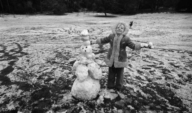Feb. 5, 1976: A girl builds a snowman in Golden Gate Park during a rare San Francisco snowfall in 1976. 