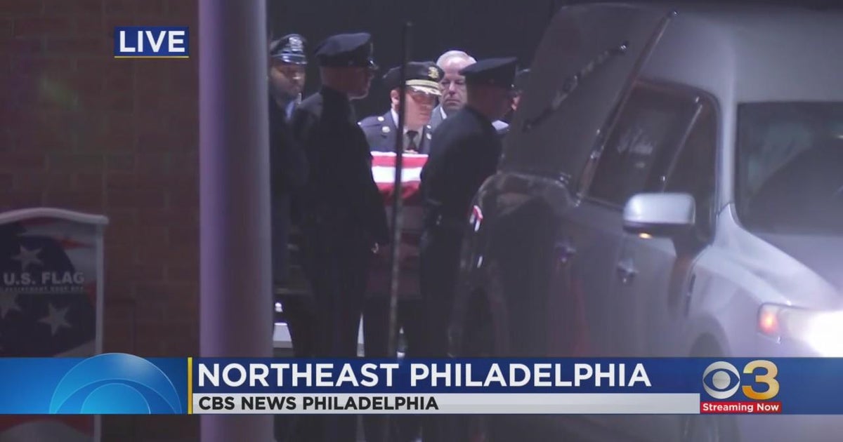 Officers transporting Chris Fitzgerald's casket for funeral Mass CBS