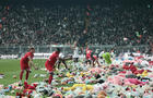 Fans throw toys on the soccer pitch for children affected by earthquake during a match, in Istanbul 