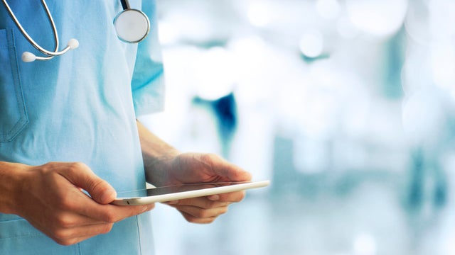 An old man is happy to be touched by a nurse on March 30, 2022 in Heidelberg, Germany. (Photo 