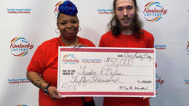 Tyesha Trice and Dylan Mitchell holding a big check with their winnings 