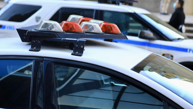 Police vehicles with overhead strobe lights at a crime scene 