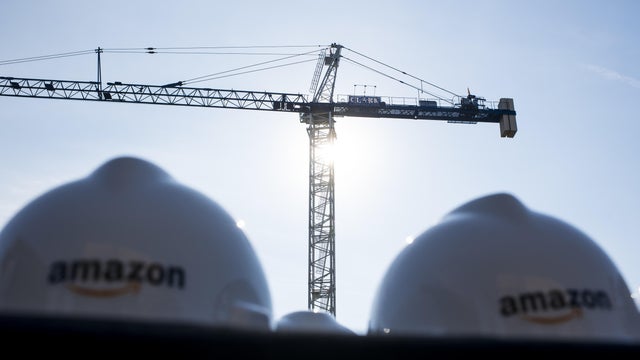Crane with two hard hats in foreground 