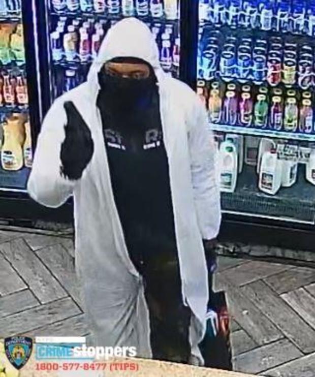 Surveillance photo of a man wanted in connection to a robbery. 