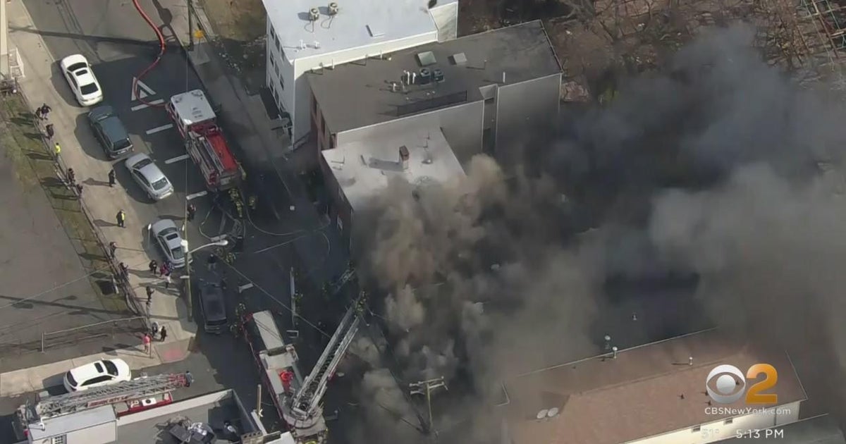 Three rescued from burning building in Jersey City - CBS New York