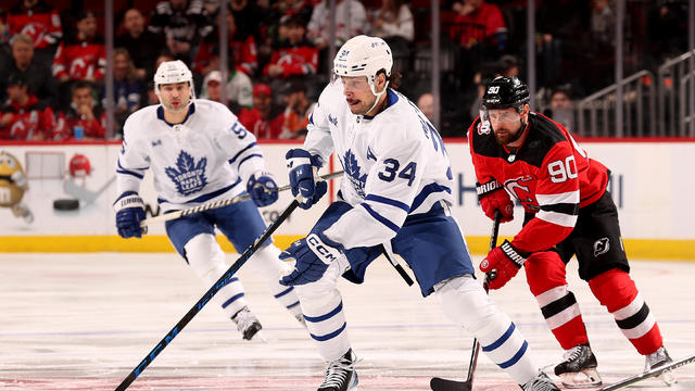 Auston Matthews #34 of the Toronto Maple Leafs and Tomas Tatar #90 of the New Jersey Devils fight for the puck during the first period at Prudential Center on March 07, 2023 in Newark, New Jersey. 