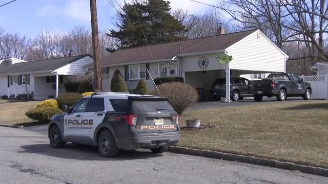 A Roxbury Township Police vehicle sits parked outside a home. 