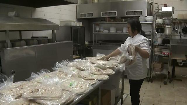 A woman works at Al Mazaq Restaurant and Bakery in Paterson. 