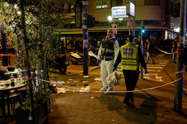 Israeli security personnel work at the scene of a shooting attack in central Tel Aviv 