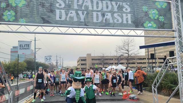 jason-the-lucky-leprechaun-and-guaranty-bank-trust-mascot-cash-prepare-to-send-runners-off-on-the-5k-course.jpg 