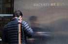 A worker arrives to the Signature Bank HQ in New York City 