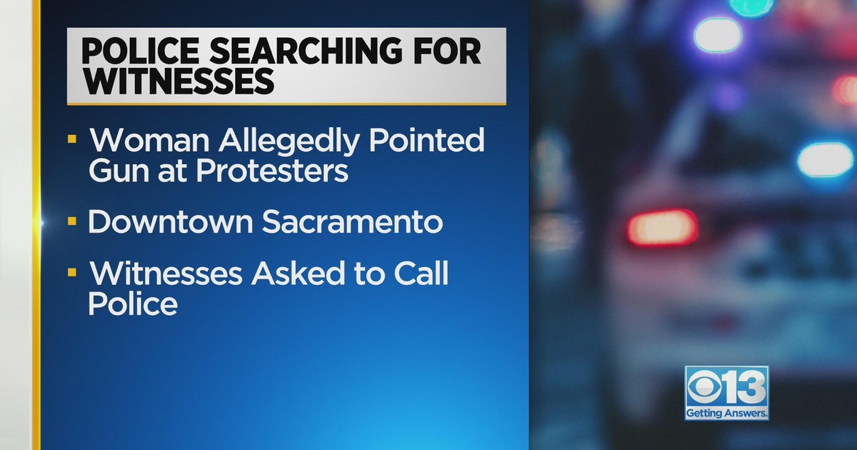 Police searching for woman accused of pointing gun at protesters