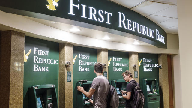 Two boys using First Republic Bank ATMs in the 30 Rockefeller Center. 