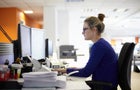 Young woman using computer in office 
