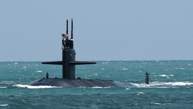 A nuclear-powered U.S. Navy submarine cruises into the Navy 