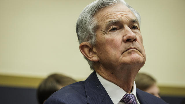 Headshot of Jerome Powell in a suit looking tired 