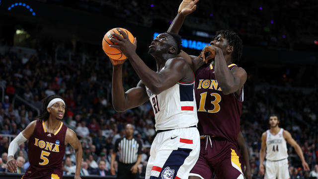 Adama Sanogo #21 of the Connecticut Huskies looks to shoot against Nelly Junior Joseph #13 of the Iona Gaels in the second half during the first round of the NCAA Men's Basketball Tournament at MVP Arena on March 17, 2023 in Albany, New York. 