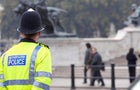 A British cop standing guard at Buckingham Palace 