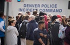Parents wait for students to be walked out after two administrators were shot and wounded after a handgun was found during a daily search of a student at Denver's East High School March 22, 2023. 