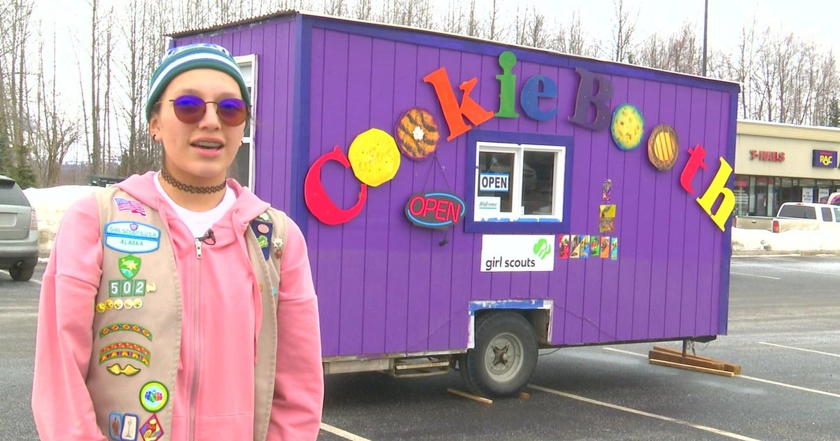 Girl Scout doing brisk business with drive-up cookie kiosk