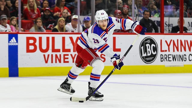 Adam Fox #23 of the New York Rangers passes the puck during the first period of the game against Carolina Hurricanes at PNC Arena on March 23, 2023 in Raleigh, North Carolina. 