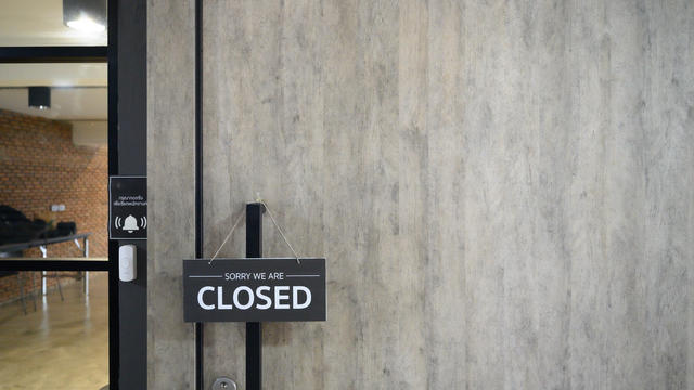 Closed sign hung on wooden door 