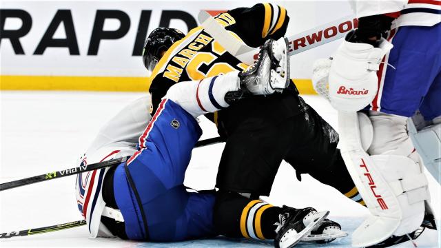 Brad Marchand throws a punch at Rem Pitlick 