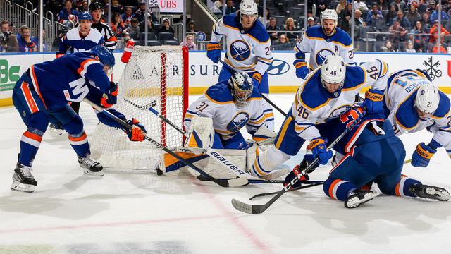 Eric Comrie #31 of the Buffalo Sabres makes the save against Bo Horvat #14 of the New York Islanders during the first period at UBS Arena on March 25, 2023 in Elmont, New York. 