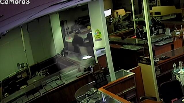 Thieves fill a bag with jewelry inside a Bergen County jewelry store. 