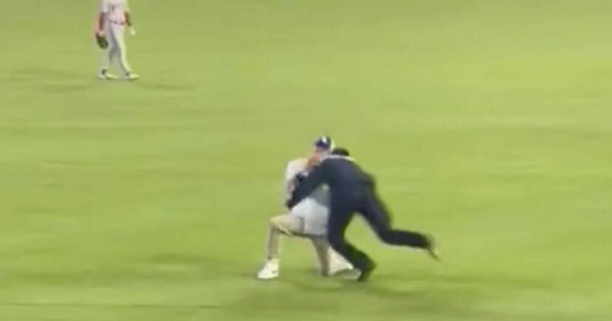 A Dodgers fan took to the outfield to propose to his girlfriend in the stands— then got tackled by security