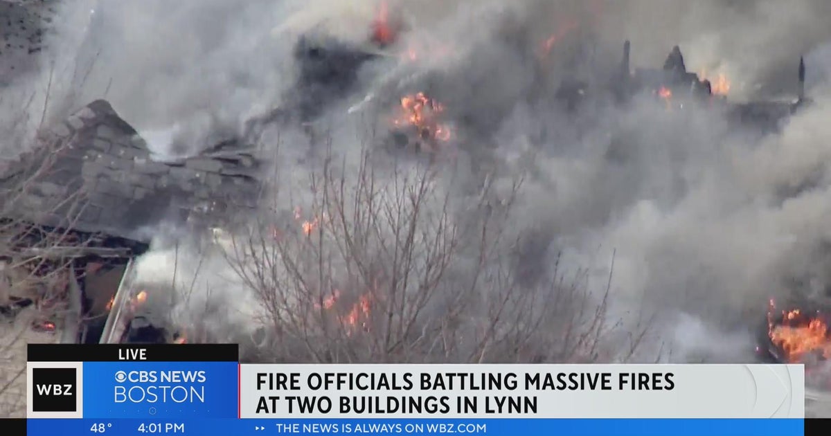Firefighters work to extinguish two house fire in Lynn - CBS Boston